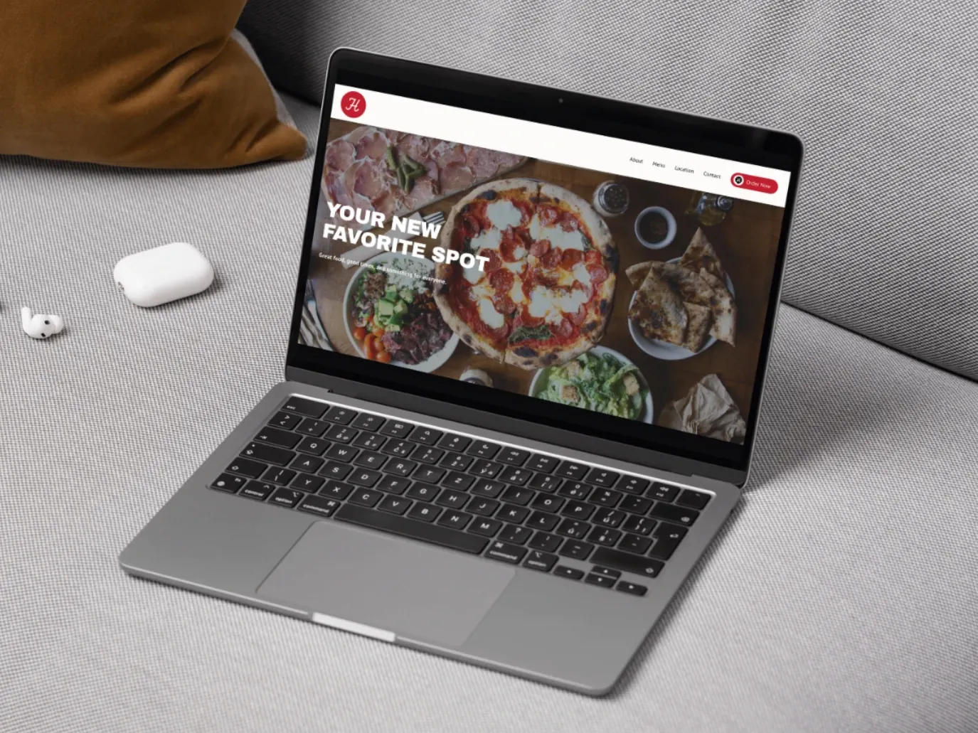 Laptop on a sofa showing a restaurant online ordering page