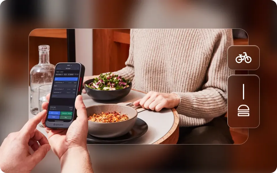 Hands holding a phone showing an ordering app above a bowl of food